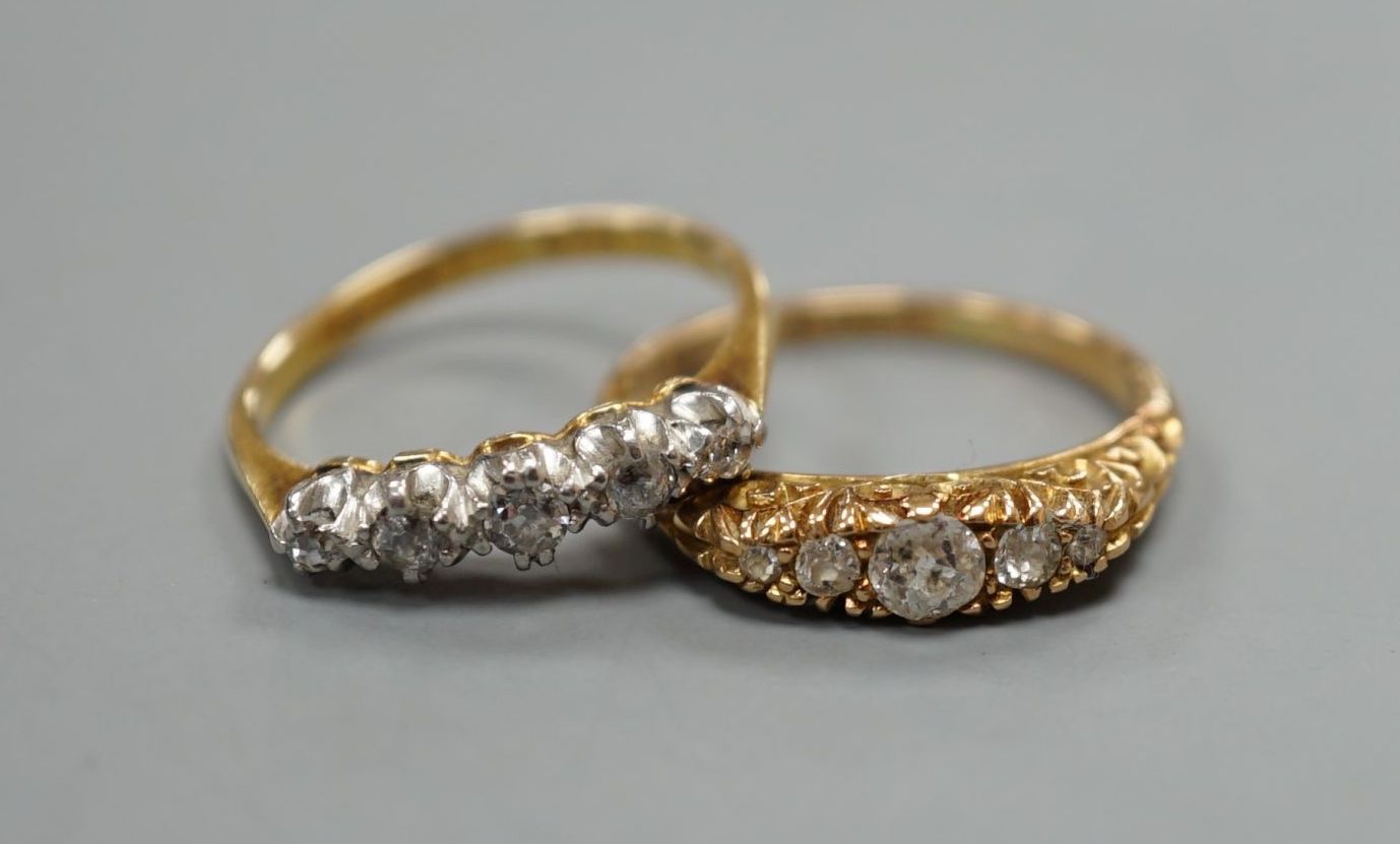 Two early 20th century 18ct and graduated five stone diamond set half hoop rings, gross 5.9 grams.